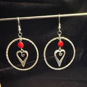 Chic silver color hoop earrings hang 2 1/2 inches.